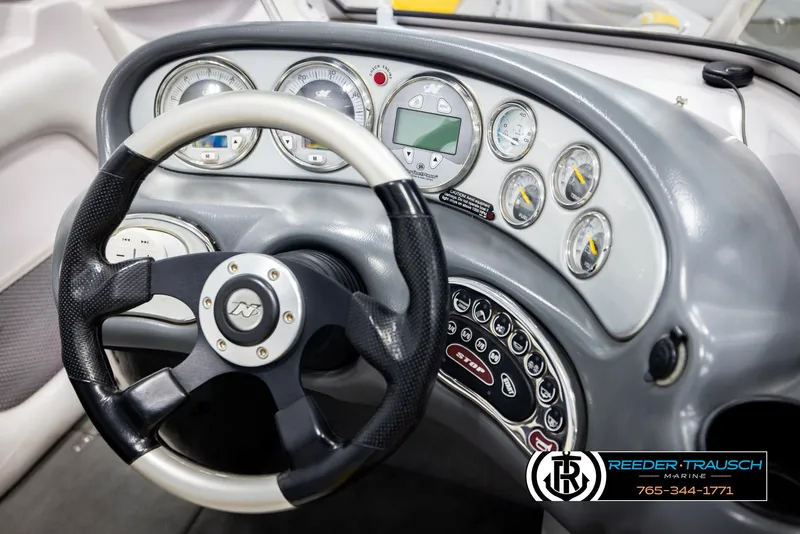 Slide: The Image of 2005 Correct Craft 226 Natique dashboard with steering wheel and instrument panel. - 30