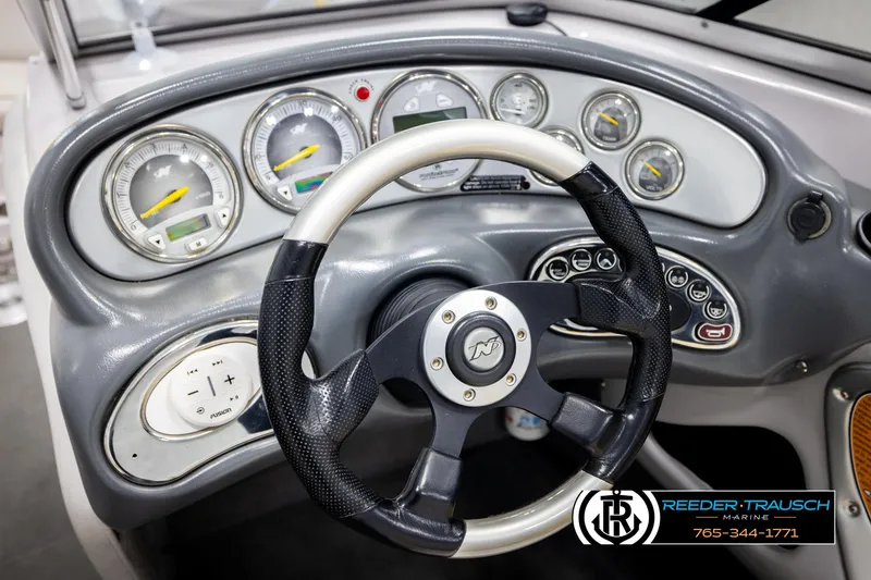 Slide: The Image of 2005 Correct Craft 226 Natique dashboard with steering wheel and gauges. - 31