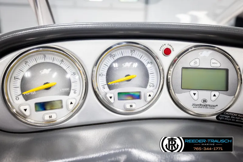 Slide: The Image of Dashboard of a 2005 Correct Craft 226 Natique boat with gauges and controls. - 34