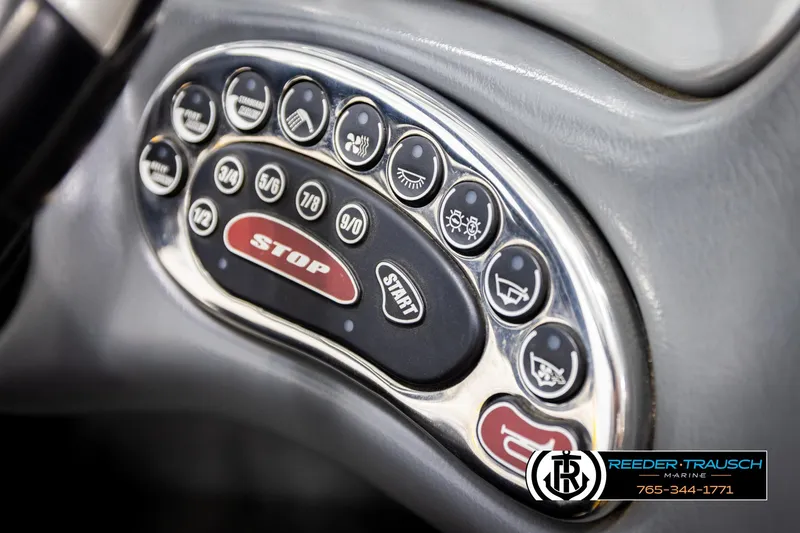 Slide: The Image of Dashboard controls of a 2005 Correct Craft 226 Nautique boat, featuring start and stop buttons. - 36