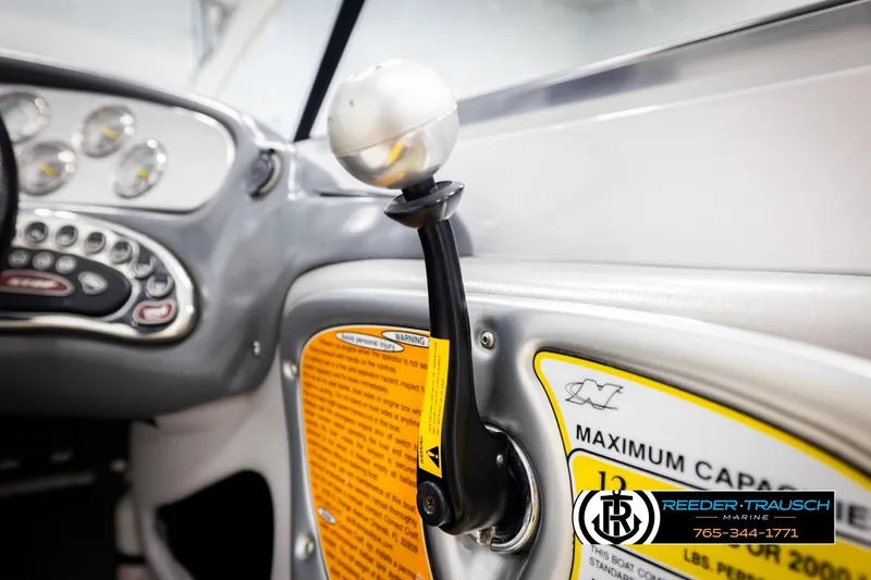 Slide: The Image of 2005 Correct Craft 226 Nautique dashboard and throttle lever close-up. - 37