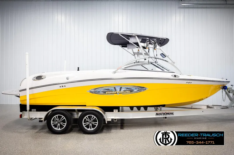 Slide: The Image of 2005 Correct Craft 226 Natique boat in yellow on trailer, indoor showroom. - 4