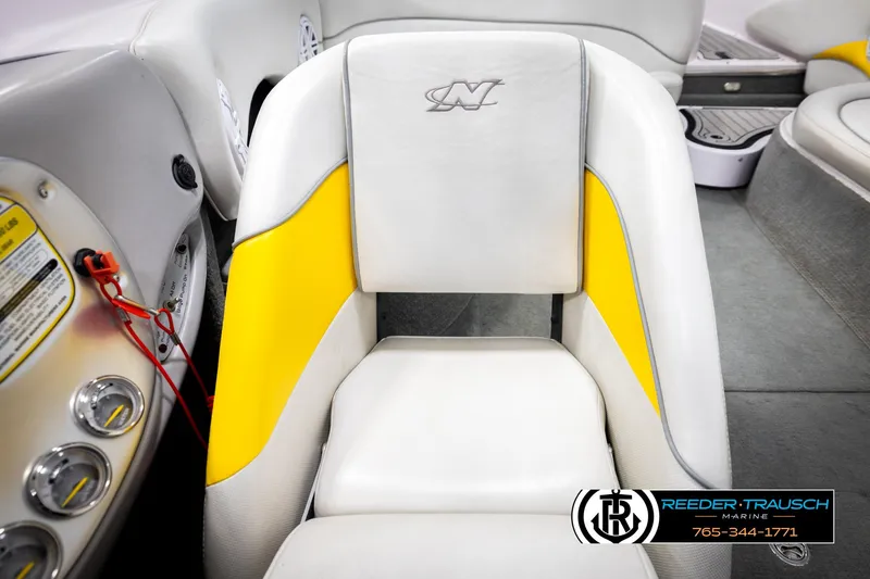 Slide: The Image of 2005 Correct Craft 226 Natique boat interior with yellow and white seating. - 40