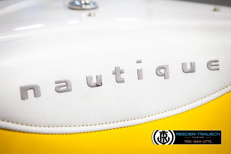 Slide: The Image of 2005 Correct Craft 226 Nautique logo on white and yellow boat upholstery. - 43