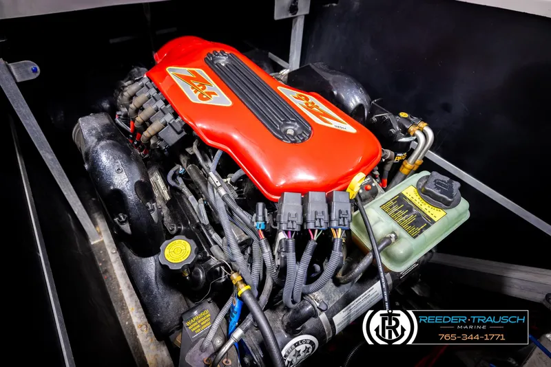 Slide: The Image of 2005 Correct Craft 226 Natique engine with red cover, detailed view. - 49