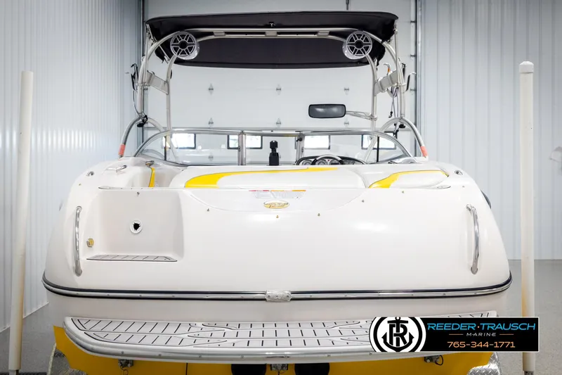 Slide: The Image of 2005 Correct Craft 226 Nautique boat in storage, rear view with speakers and canopy. - 6