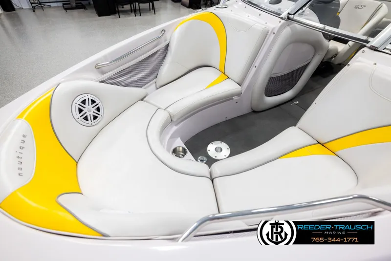 Slide: The Image of 2005 Correct Craft 226 Nautique boat interior with yellow and white seating. - 9