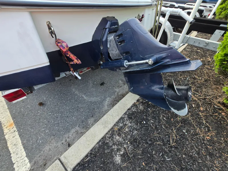 Slide: The Image of 2002 Glastron DX 215 boat outboard motor and propeller on a trailer. - 10