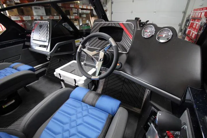 Slide: The Image of 2025 Vexus DVX22S boat interior with modern dashboard and blue seating. - 12