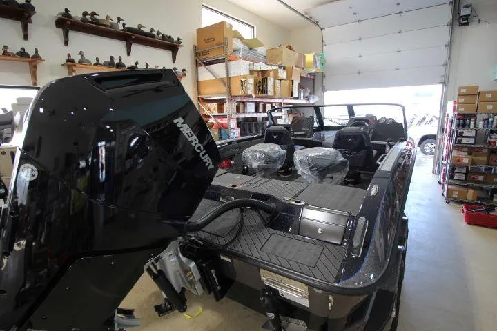 Slide: The Image of 2025 Vexus DVX22S boat with Mercury engine in a garage setting. - 5