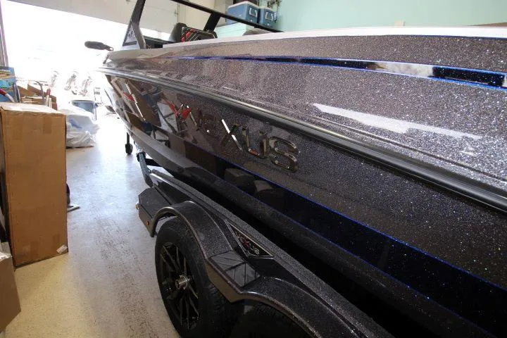 Slide: The Image of 2025 Vexus DVX22S boat with metallic finish in a garage setting. - 8