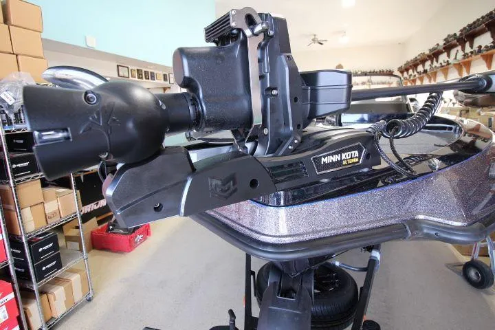 Slide: The Image of 2025 Vexus DVX22S boat with Minn Kota trolling motor in a showroom. - 9