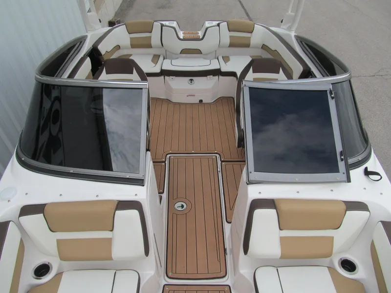 Slide: The Image of 2022 Yamaha Boats 195S interior with tan and white seating, wood-style flooring. - 10