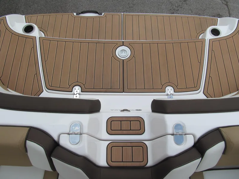 Slide: The Image of 2022 Yamaha Boats 195S swim platform with brown decking and seating. - 13