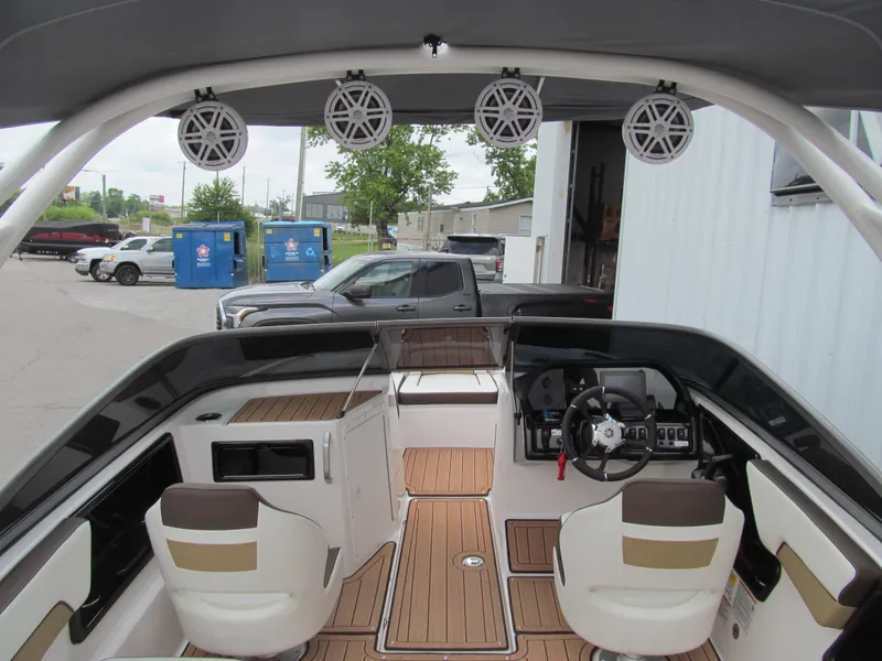 Slide: The Image of 2022 Yamaha Boats 195S interior with modern dashboard and seating, featuring wood-style flooring. - 4