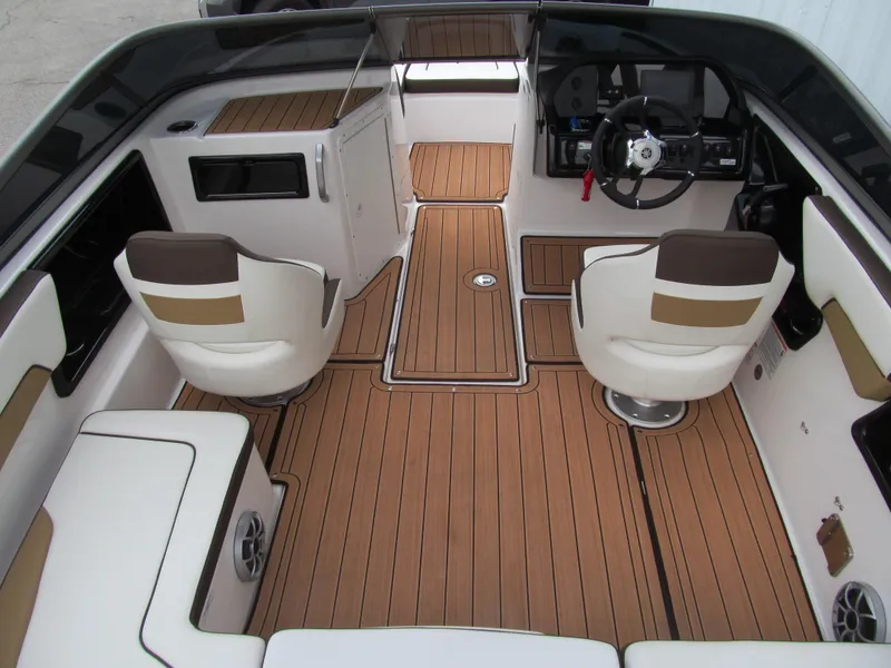 Slide: The Image of 2022 Yamaha Boats 195S interior with sleek seating and wood-style flooring. - 5