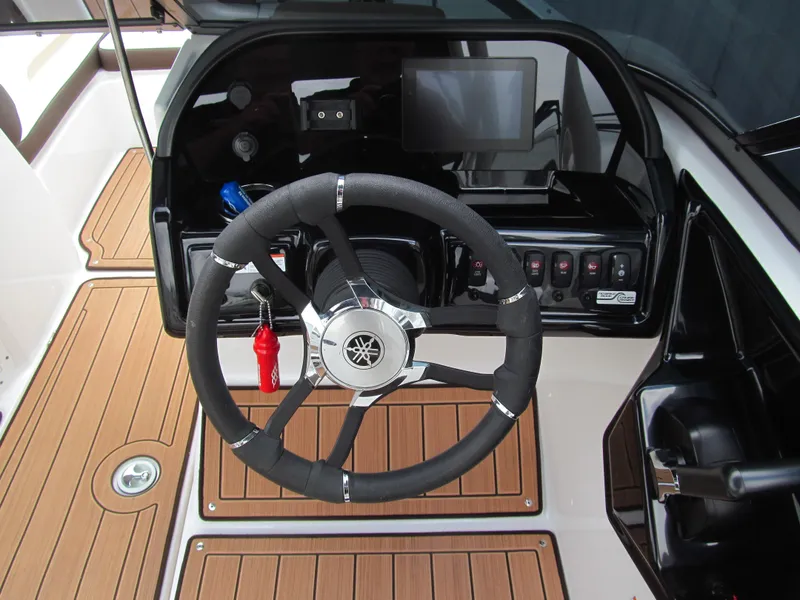 Slide: The Image of 2022 Yamaha Boats 195S steering wheel and dashboard with modern controls. - 6