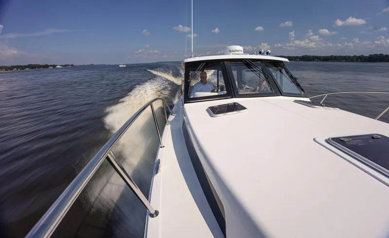 Slide: The Image of 2025 MJM 42 boat cruising on a sunny day, creating a wake on the water. - 19