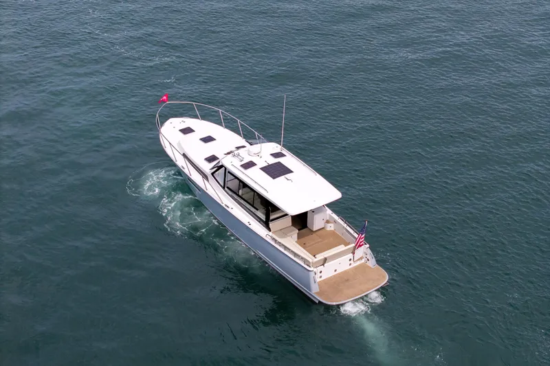 Slide: The Image of 2025 MJM 42 yacht cruising on open water, aerial view. - 2