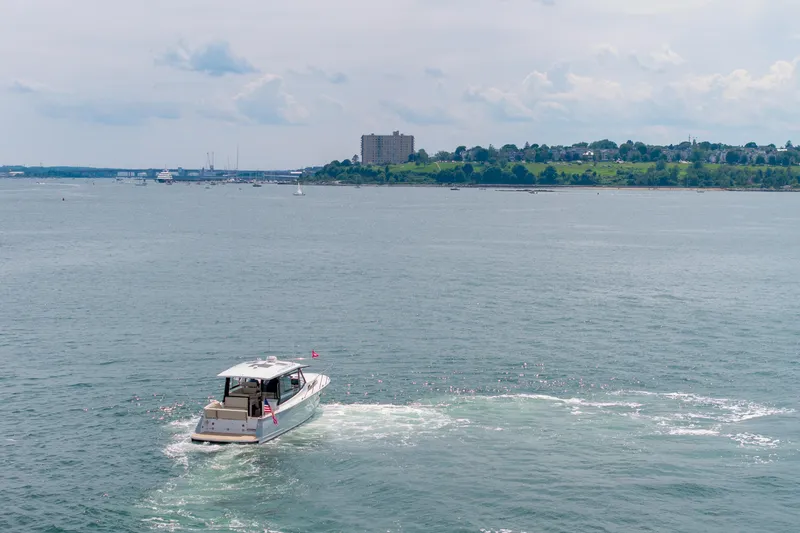 Slide: The Image of A 2025 MJM 42 boat cruising on a calm sea near a distant shoreline. - 8