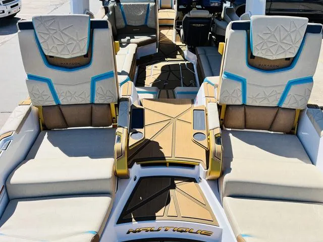 Slide: The Image of 2024 Nautique G25 Paragon boat interior with luxurious seating and modern design. - 10