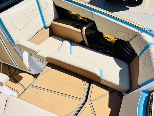 Slide: The Image of 2024 Nautique G25 Paragon interior with beige and blue seating, modern design. - 12