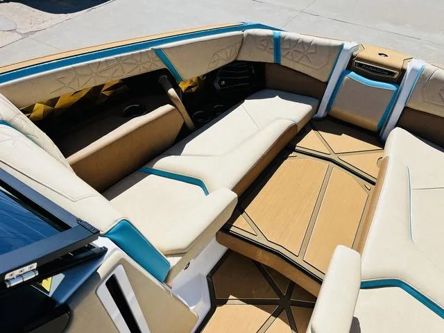 Slide: The Image of 2024 Nautique G25 Paragon boat interior with beige and blue seating, showcasing luxury design. - 13