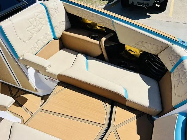 Slide: The Image of 2024 Nautique G25 Paragon interior with beige and blue seating, showcasing luxury design. - 15