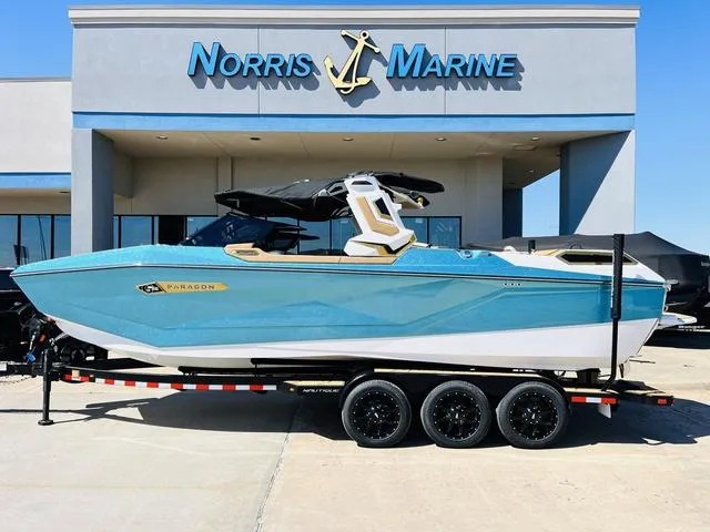 Slide: The Image of 2024 Nautique G25 Paragon boat displayed at Norris Marine dealership. - 2
