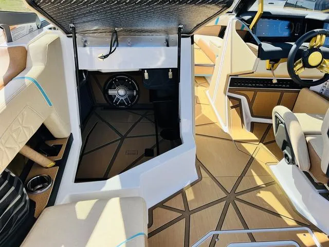 Slide: The Image of 2024 Nautique G25 Paragon interior with premium seating and advanced sound system. - 23