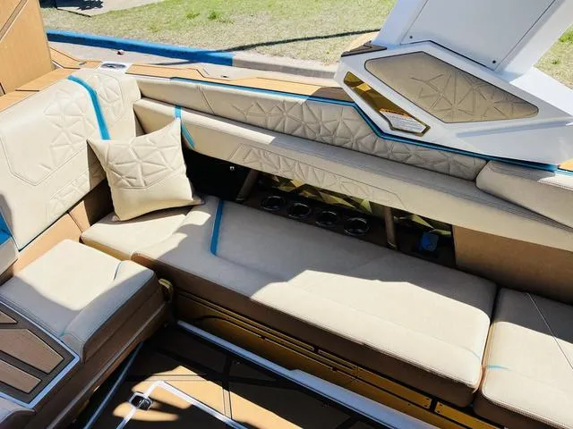 Slide: The Image of 2024 Nautique G25 Paragon interior with beige seating and geometric accents. - 25