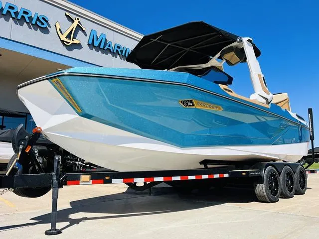 Slide: The Image of 2024 Nautique G25 Paragon boat on trailer, displayed at a marina under clear blue sky. - 3