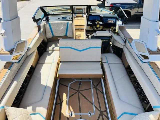 Slide: The Image of 2024 Nautique G25 Paragon boat interior with luxurious seating and modern dashboard. - 31
