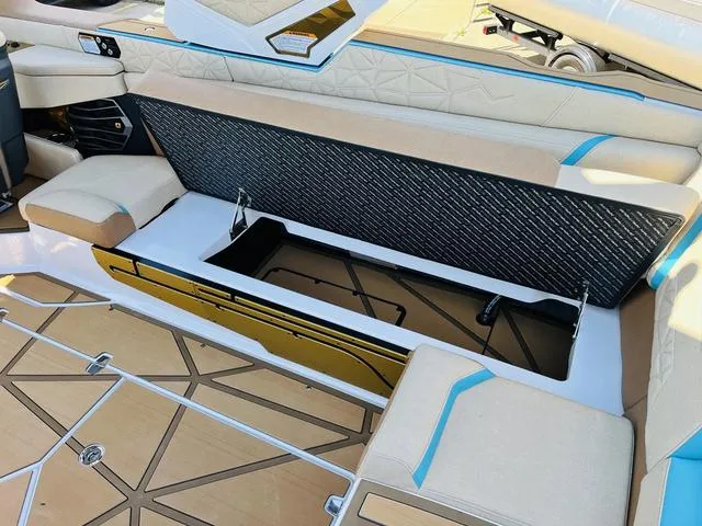 Slide: The Image of 2024 Nautique G25 Paragon boat interior with open storage compartment and luxurious seating. - 32