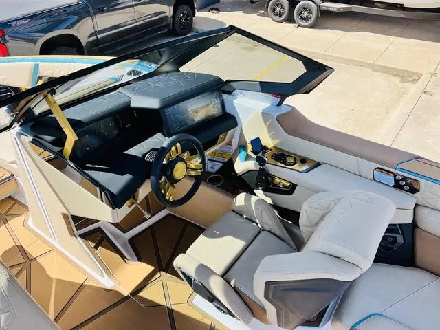 Slide: The Image of 2024 Nautique G25 Paragon boat interior with modern dashboard and luxurious seating. - 34