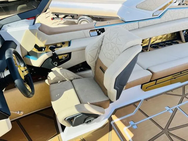 Slide: The Image of 2024 Nautique G25 Paragon interior with luxurious seating and modern dashboard design. - 35