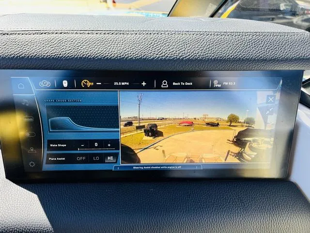 Slide: The Image of 2024 Nautique G25 Paragon dashboard display showing navigation and camera view. - 37