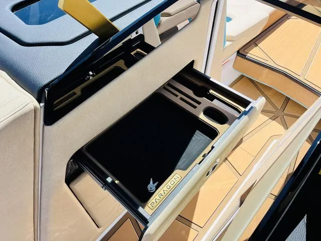 Slide: The Image of 2024 Nautique G25 Paragon interior with open storage compartment and luxury detailing. - 43