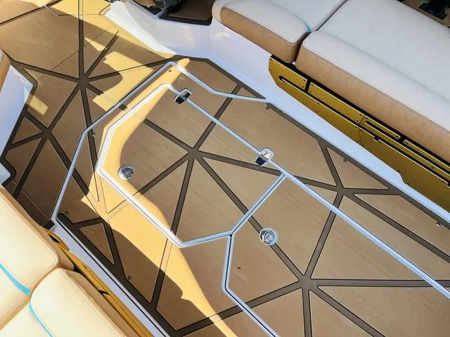 Slide: The Image of 2024 Nautique G25 Paragon boat interior with stylish seating and geometric flooring design. - 45