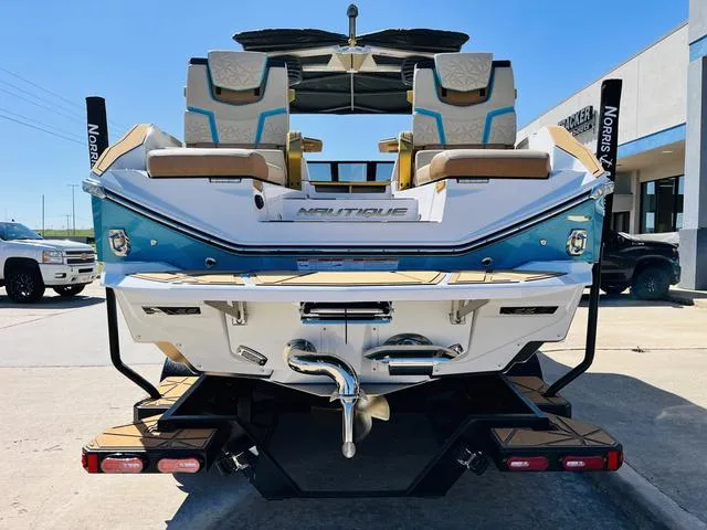 Slide: The Image of 2024 Nautique G25 Paragon boat, rear view, showcasing luxury seating and sleek design. - 6