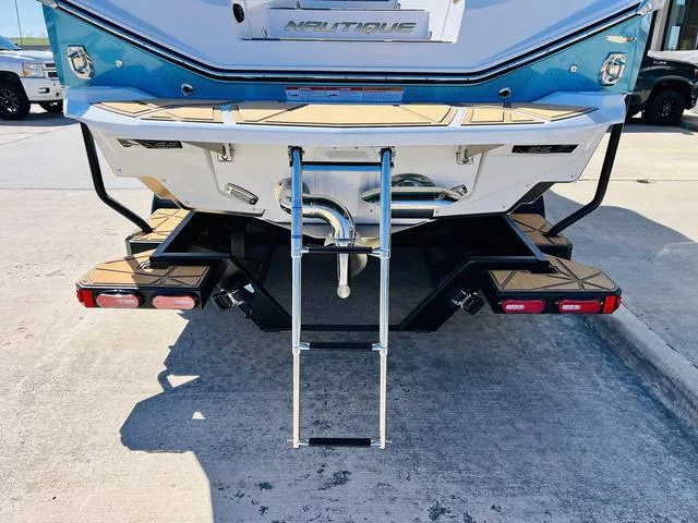 Slide: The Image of 2024 Nautique G25 Paragon boat rear view with swim platform and ladder. - 9