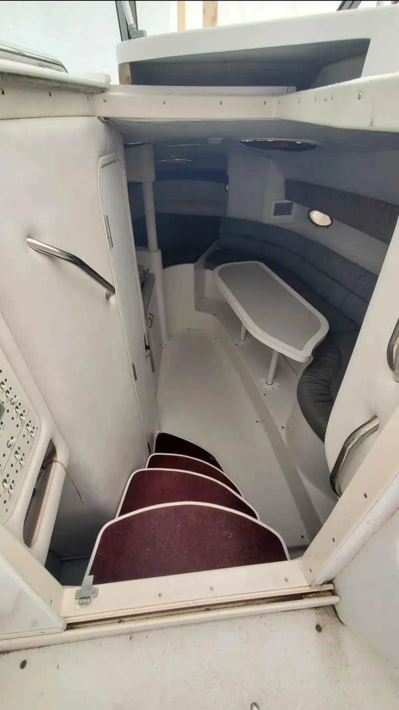 Slide: The Image of Interior view of 1997 Chris-Craft 34 boat, featuring stairs and seating area. - 11