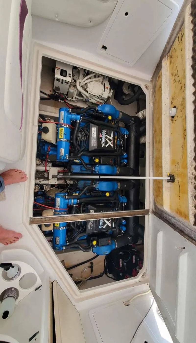 Slide: The Image of Engine compartment of a 1997 Chris-Craft 34 boat, showcasing dual engines and mechanical components. - 19