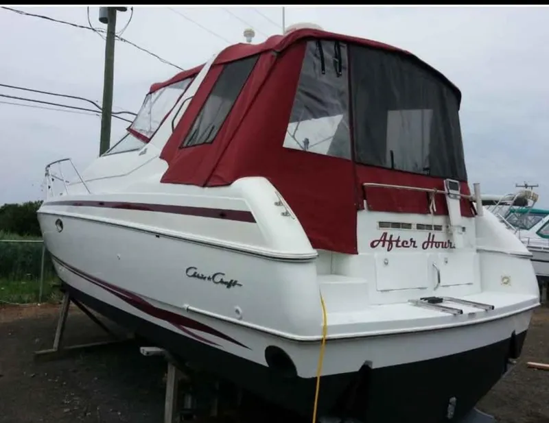 Slide: The Image of 1997 Chris-Craft 34 boat with red canopy, named "After Hours," on dry dock. - 2