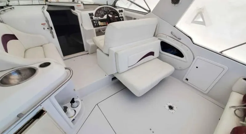 Slide: The Image of Interior of a 1997 Chris-Craft 34 boat with white seating and control panel. - 8