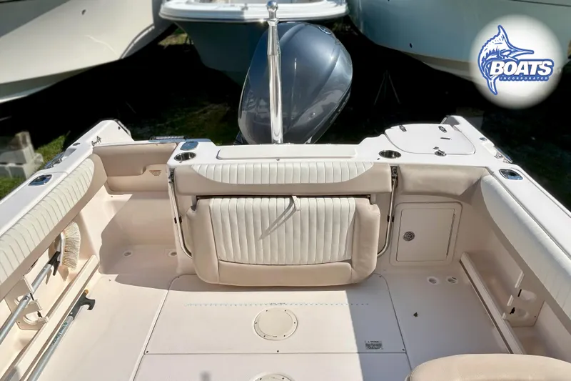 Slide: The Image of The image shows the cockpit of a Grady-White Freedom 255 boat with beige seating. - 11