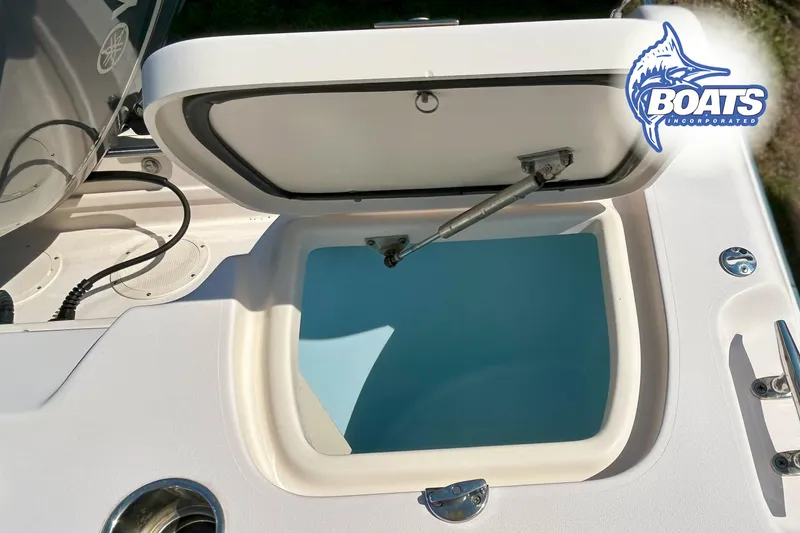 Slide: The Image of An open storage compartment on a 2014 Grady-White Freedom 255 boat. - 12