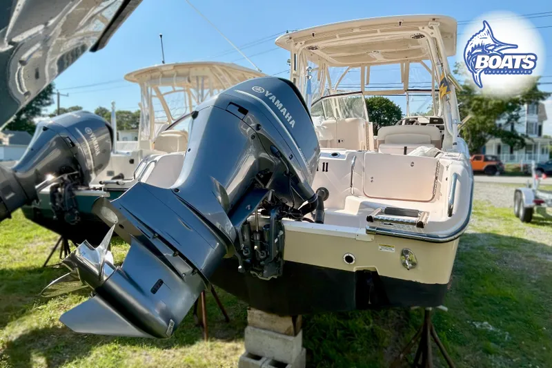Slide: The Image of A Grady-White Freedom 255 boat with Yamaha engines is on a grassy area. - 14