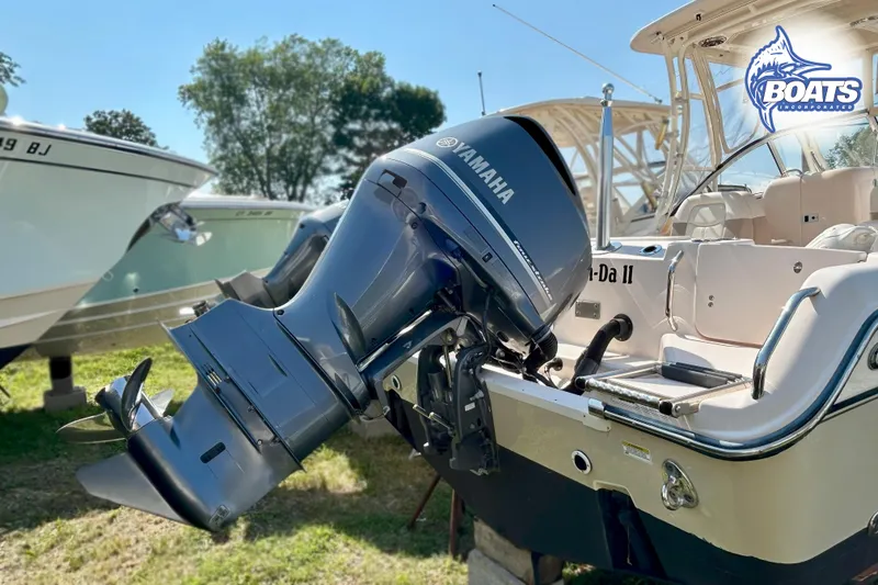 Slide: The Image of A Grady-White Freedom 255 boat with Yamaha outboard motor on a grassy area. - 15