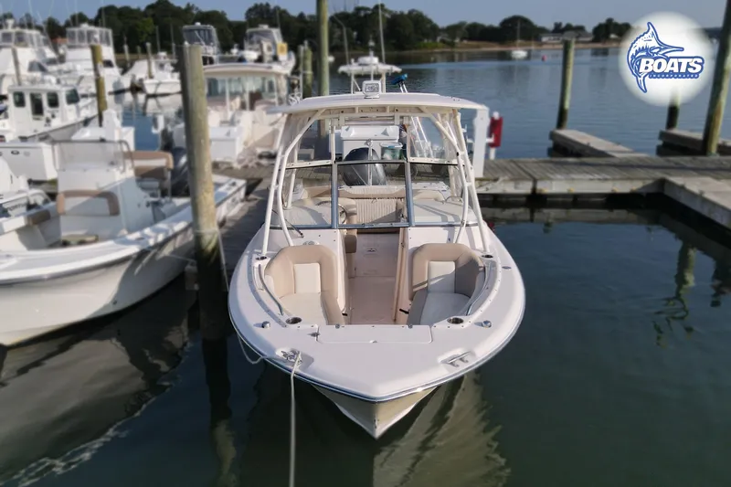 Slide: The Image of 2014 Grady-White Freedom 255 boat docked at marina, front view. - 4
